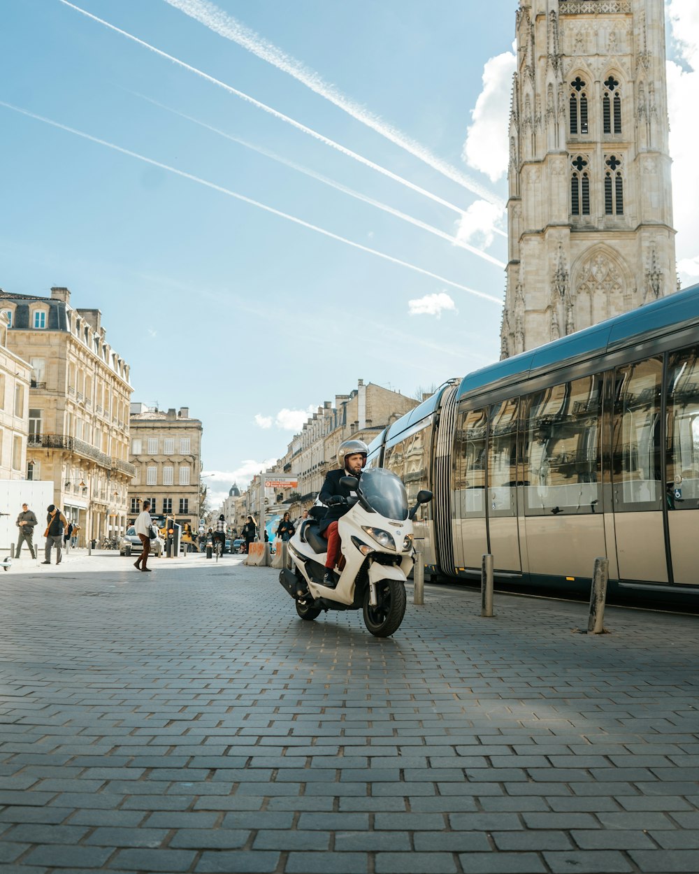 a person riding a scooter on a city street