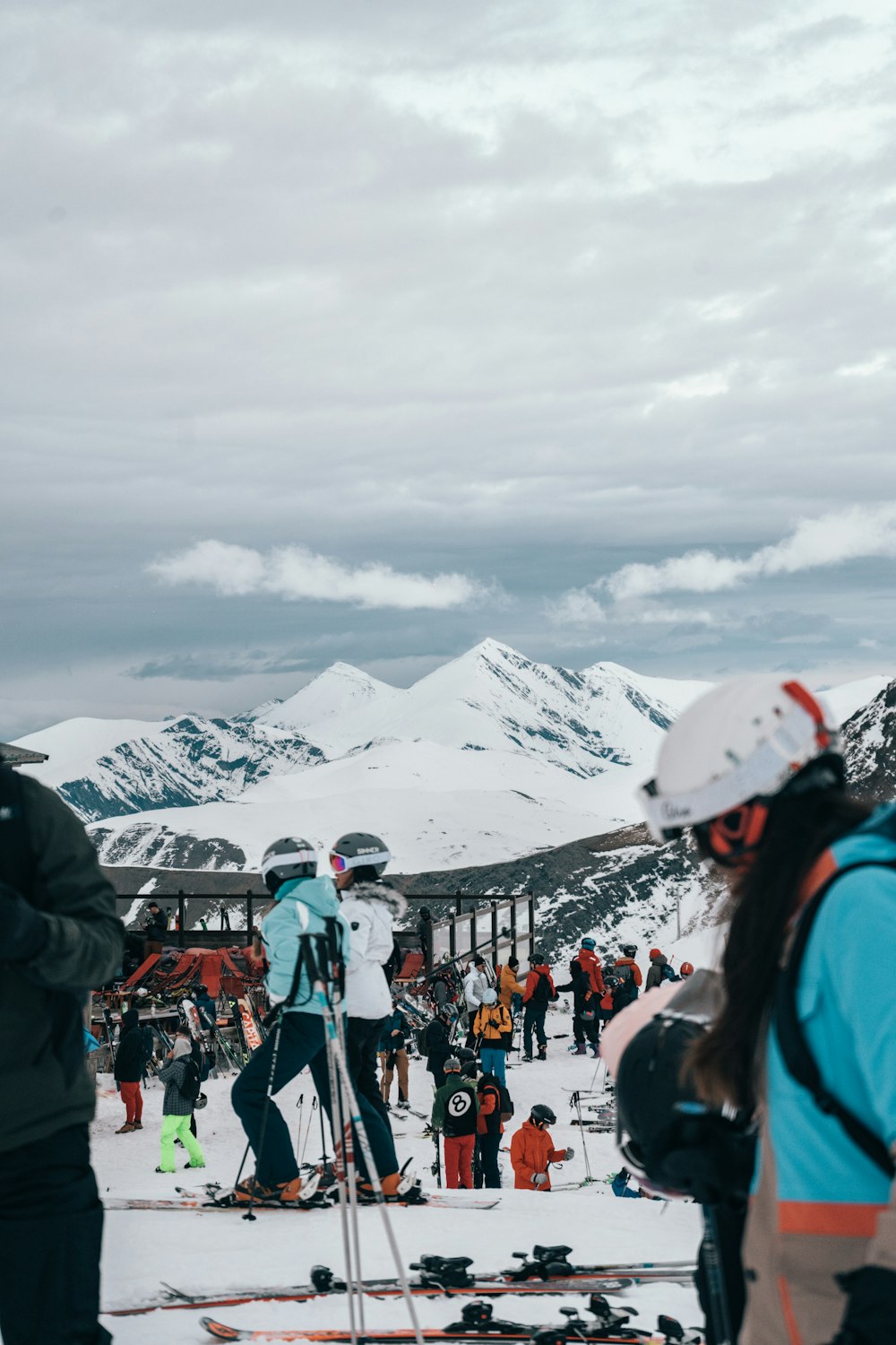 a group of people standing on top of a snow covered slope