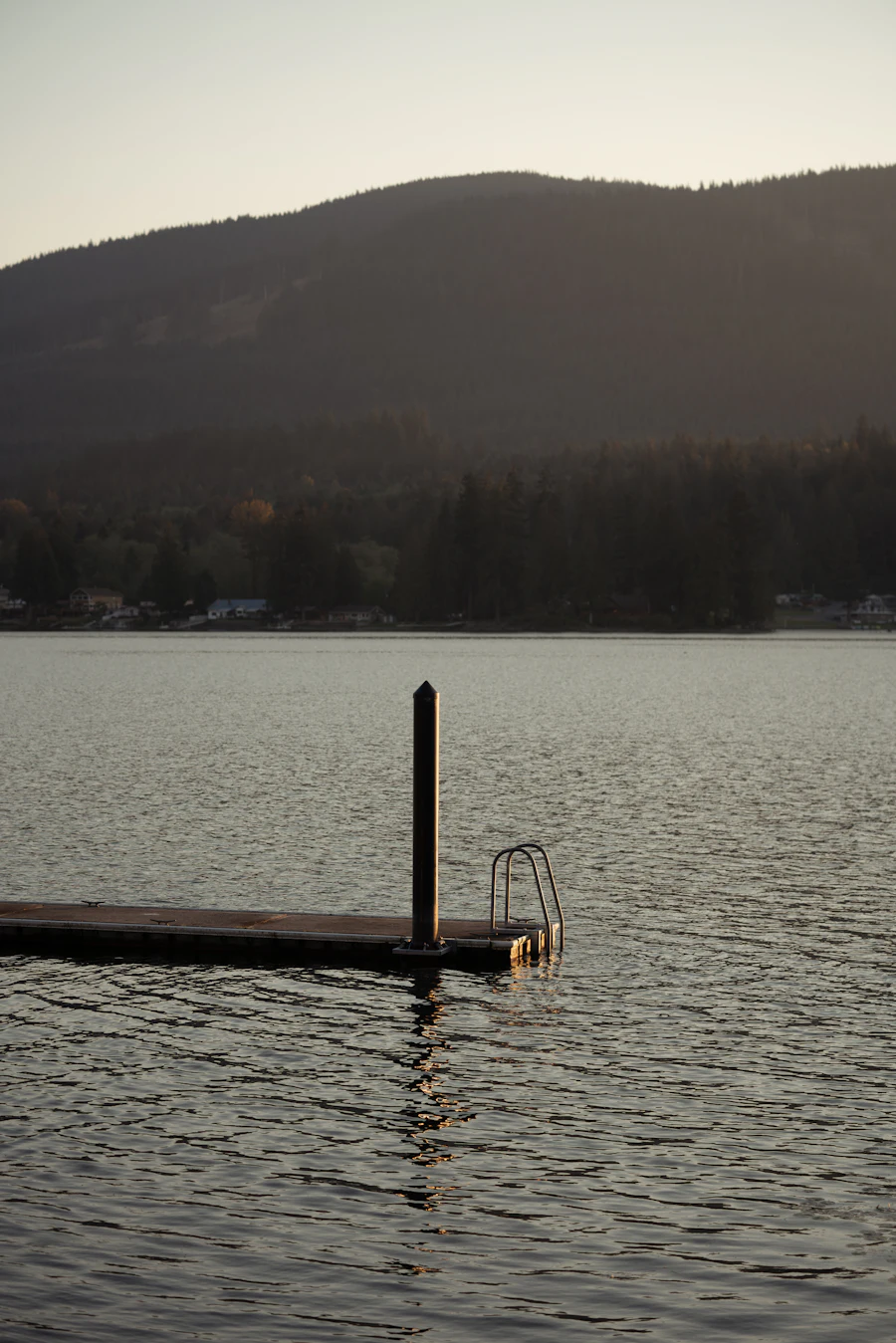 Wooden dock on a calm lake at dusk