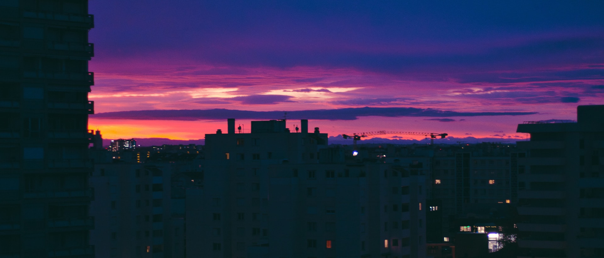 a view of a city at sunset from a high rise building
