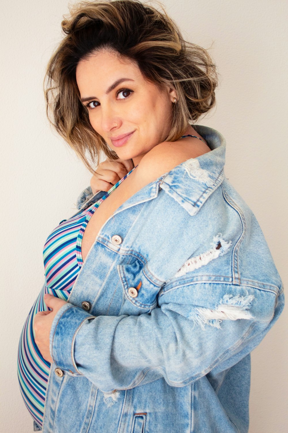 a woman in a jean jacket posing for a picture