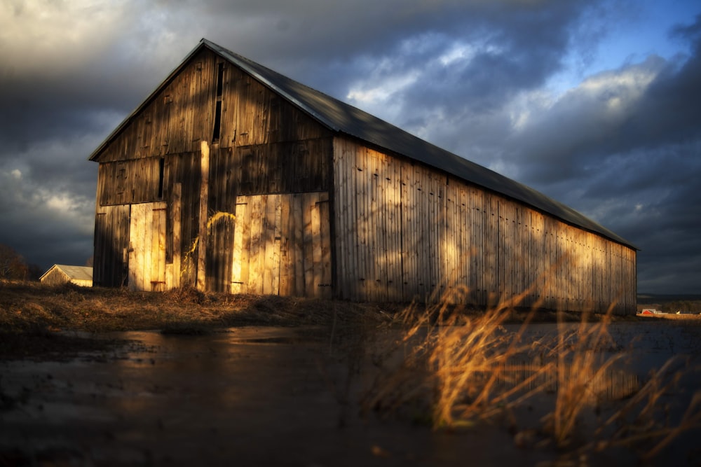 a barn with a dark sky in the background