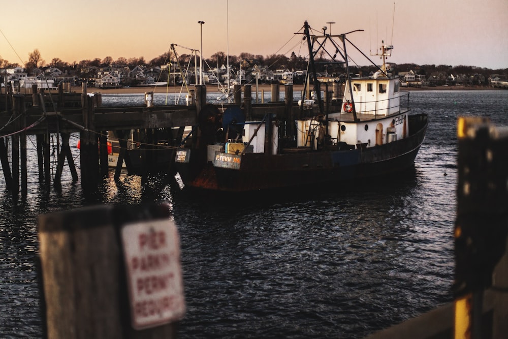 a large boat is docked at a pier