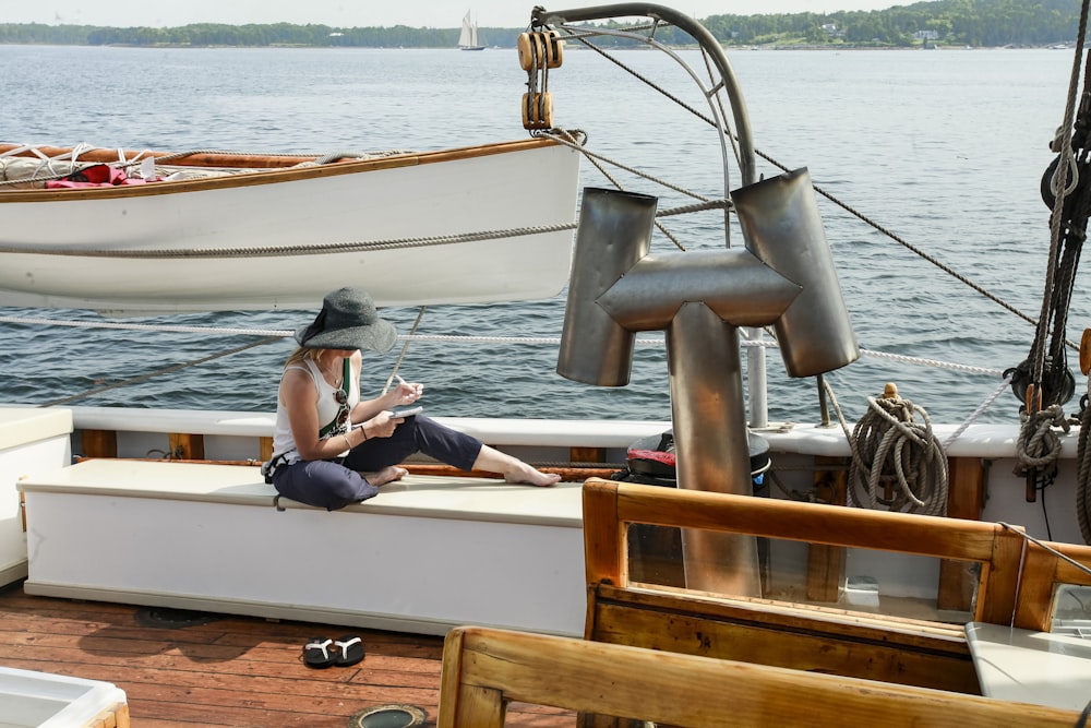 a woman sitting on a boat reading a book