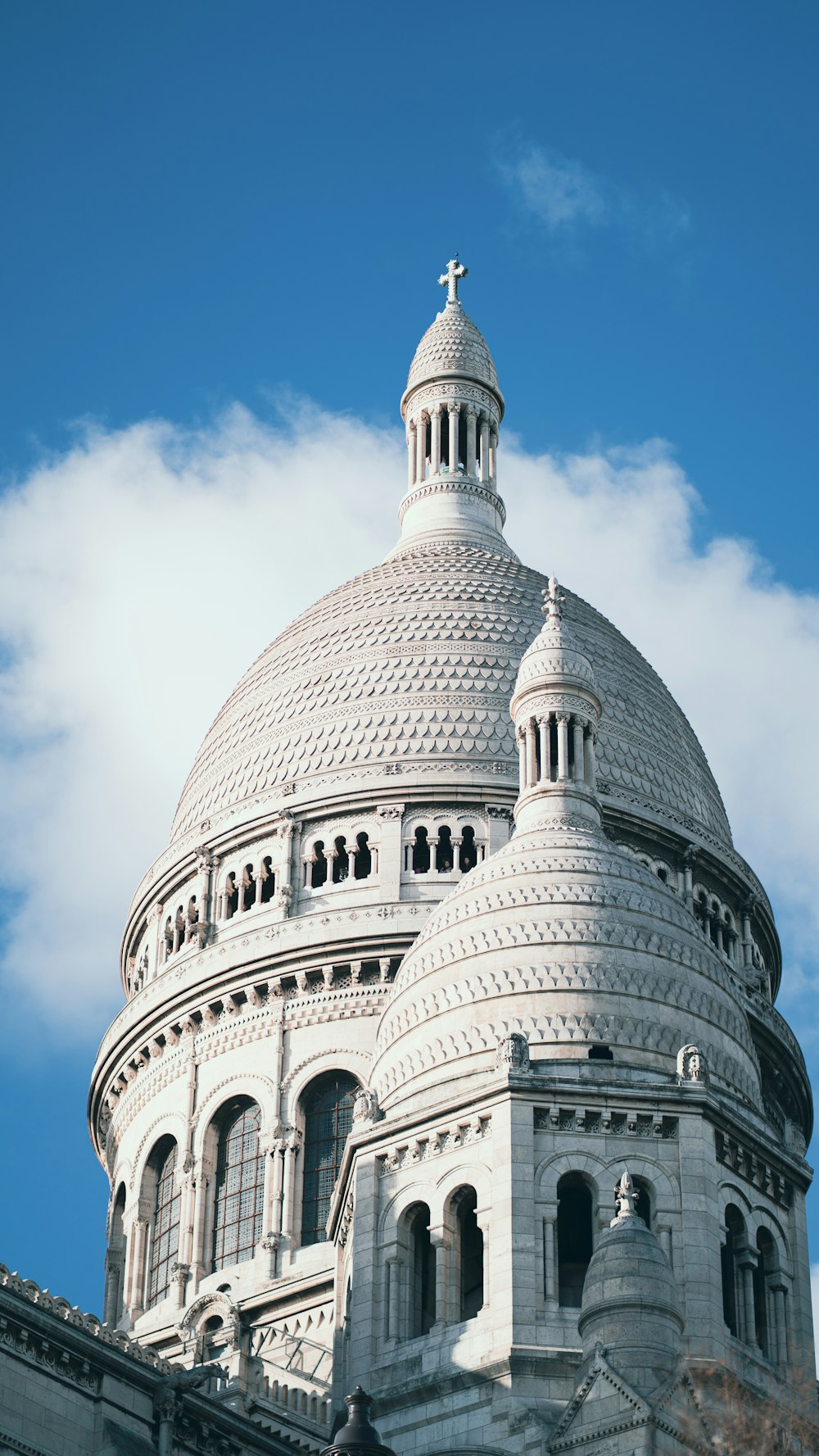 a large white building with a cross on top