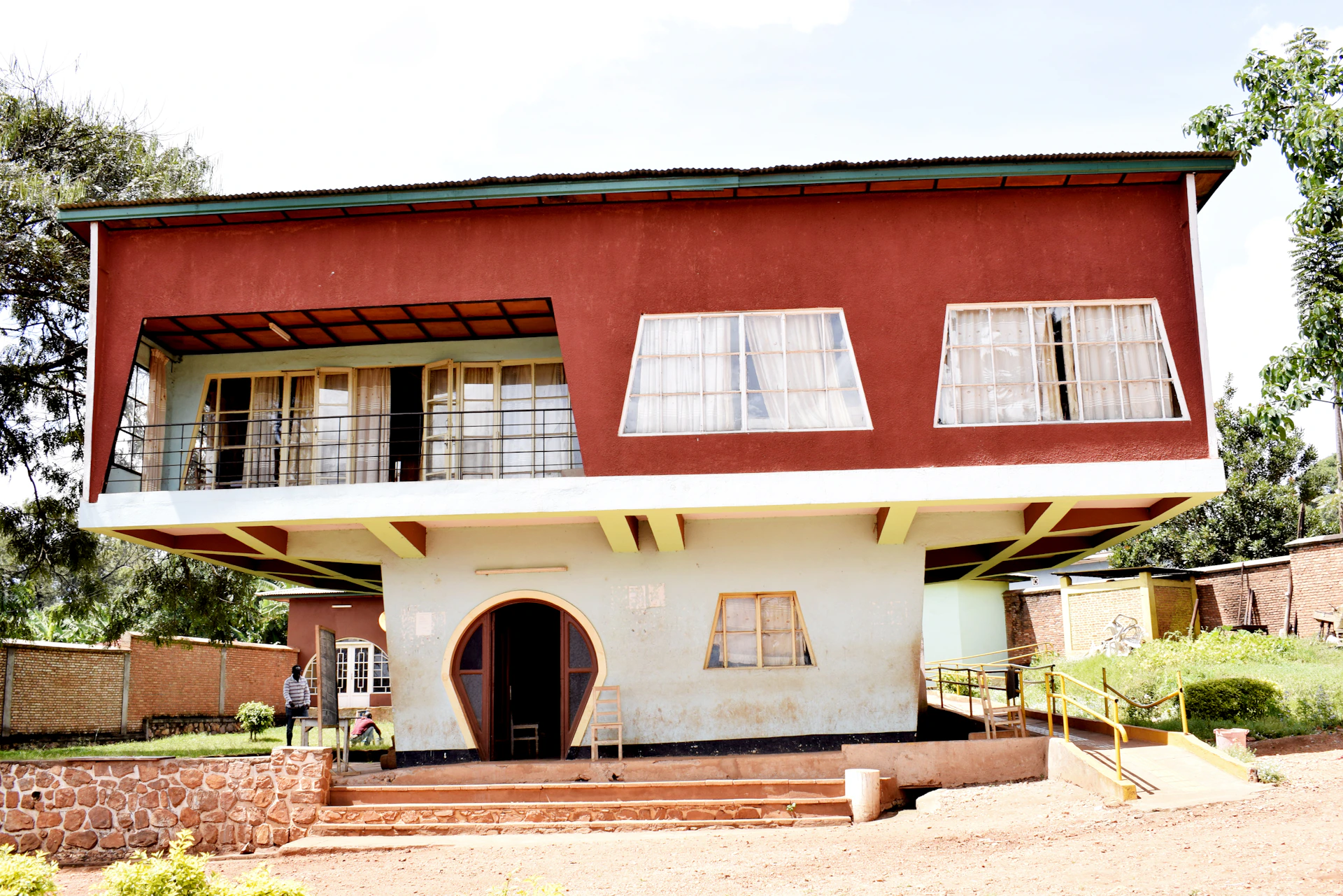 a red and white house with a balcony