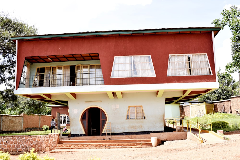 a red and white house with a balcony