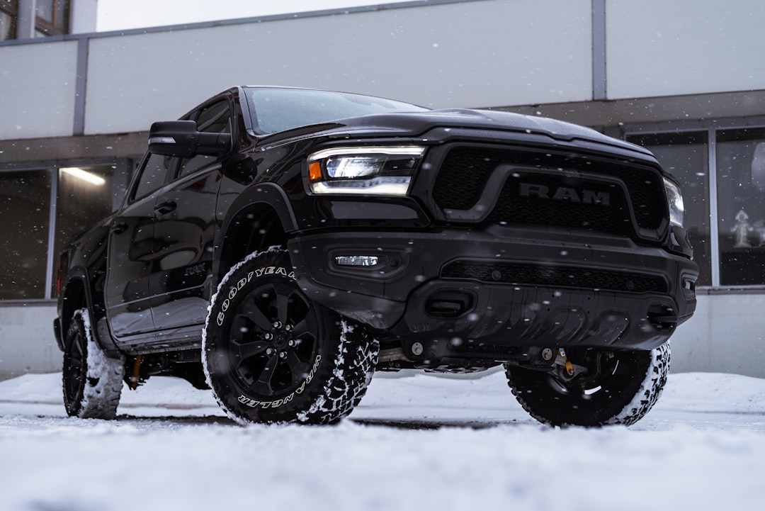 a black truck parked in front of a building,