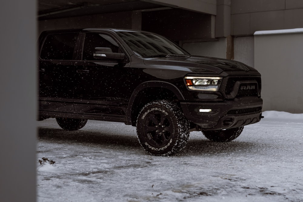 a black truck parked in a parking garage