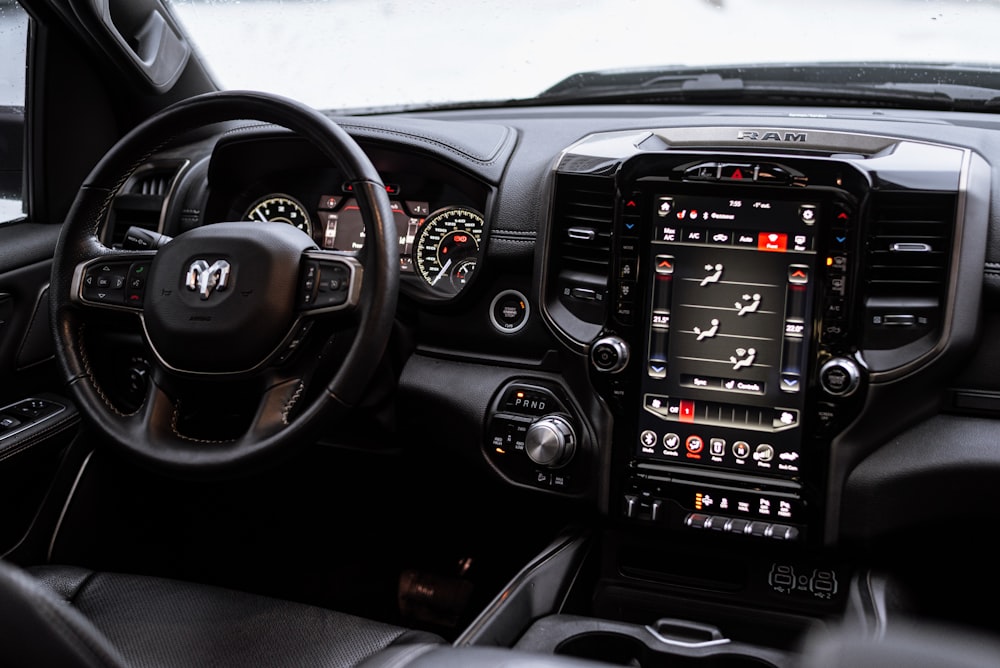 the interior of a vehicle with a steering wheel and dashboard