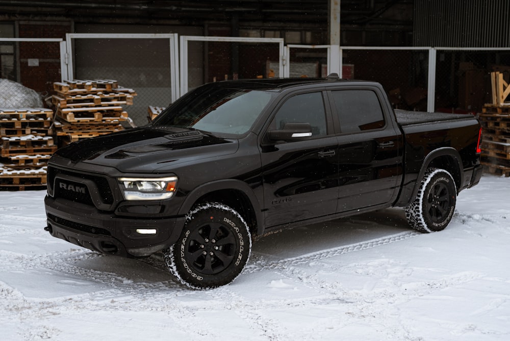 a black truck is parked in the snow
