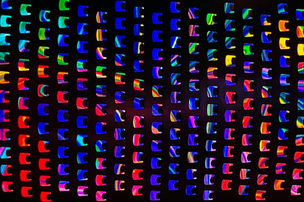 a black background with multicolored letters on it