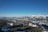 A panoramic view of snow-capped mountains under a clear blue sky.