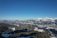 A panoramic view of snow-capped mountains under a clear blue sky.