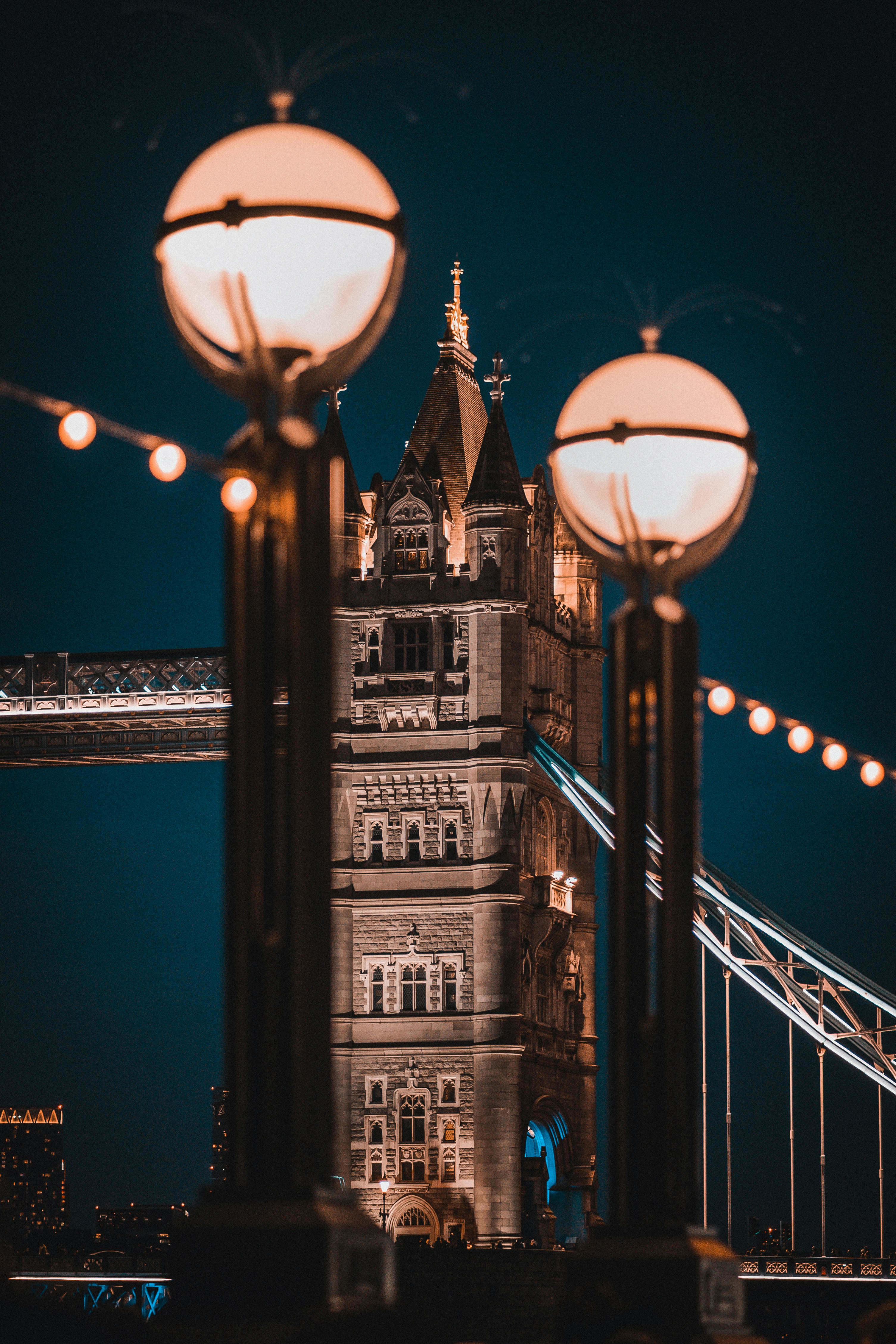 the tower bridge is lit up at night
