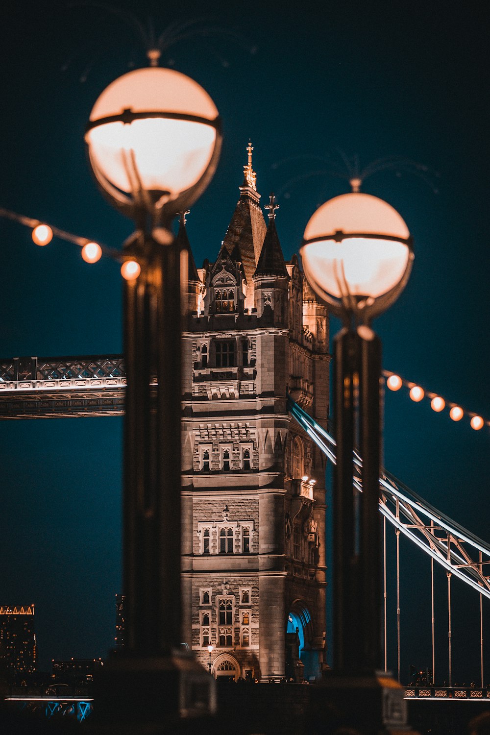 the tower bridge is lit up at night