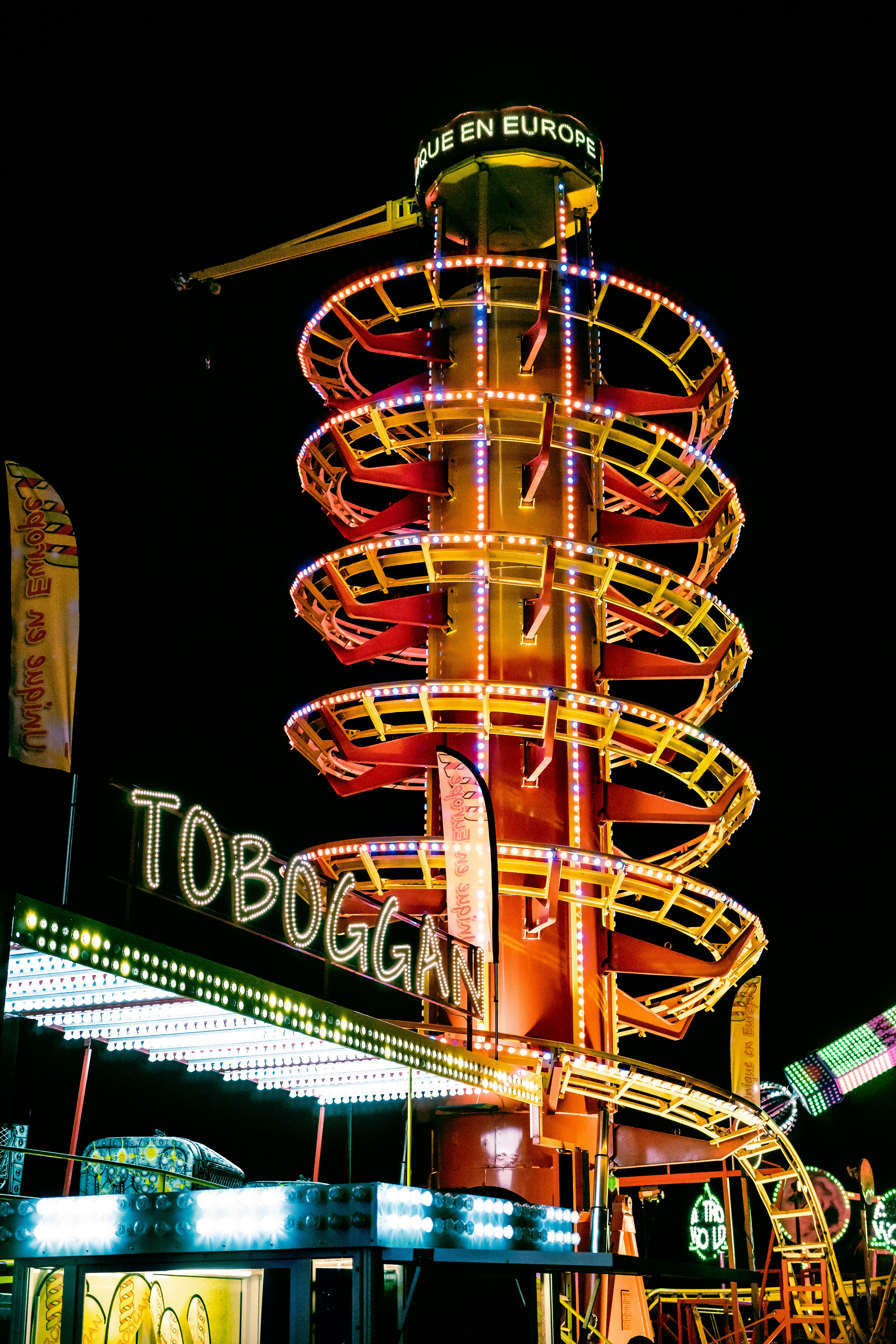 a ferris wheel lit up at night at a carnival