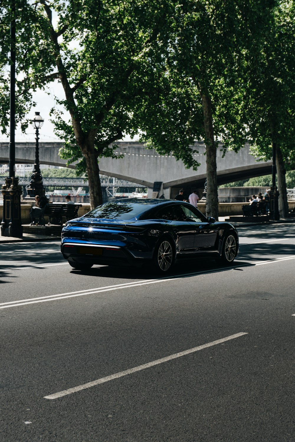 a blue sports car parked on the side of the road