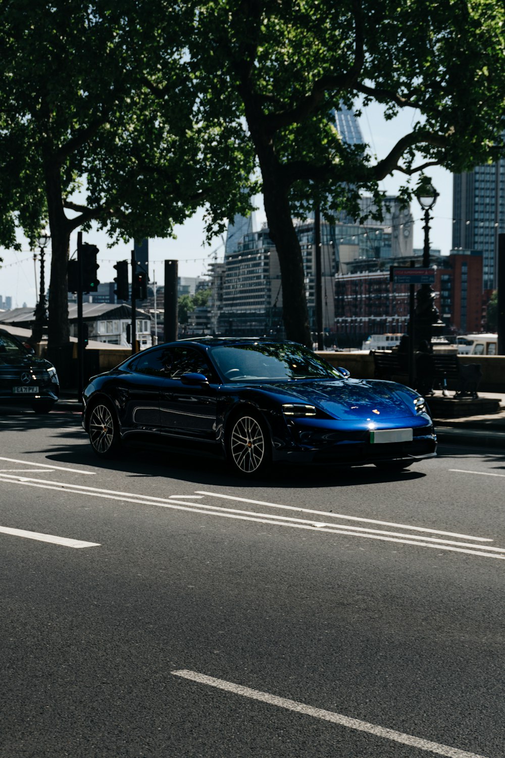 a blue sports car parked on the side of the road