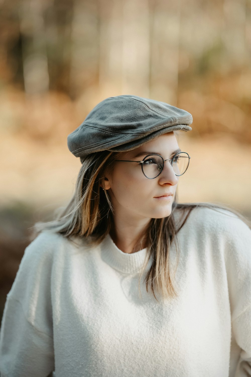 a woman wearing glasses and a hat