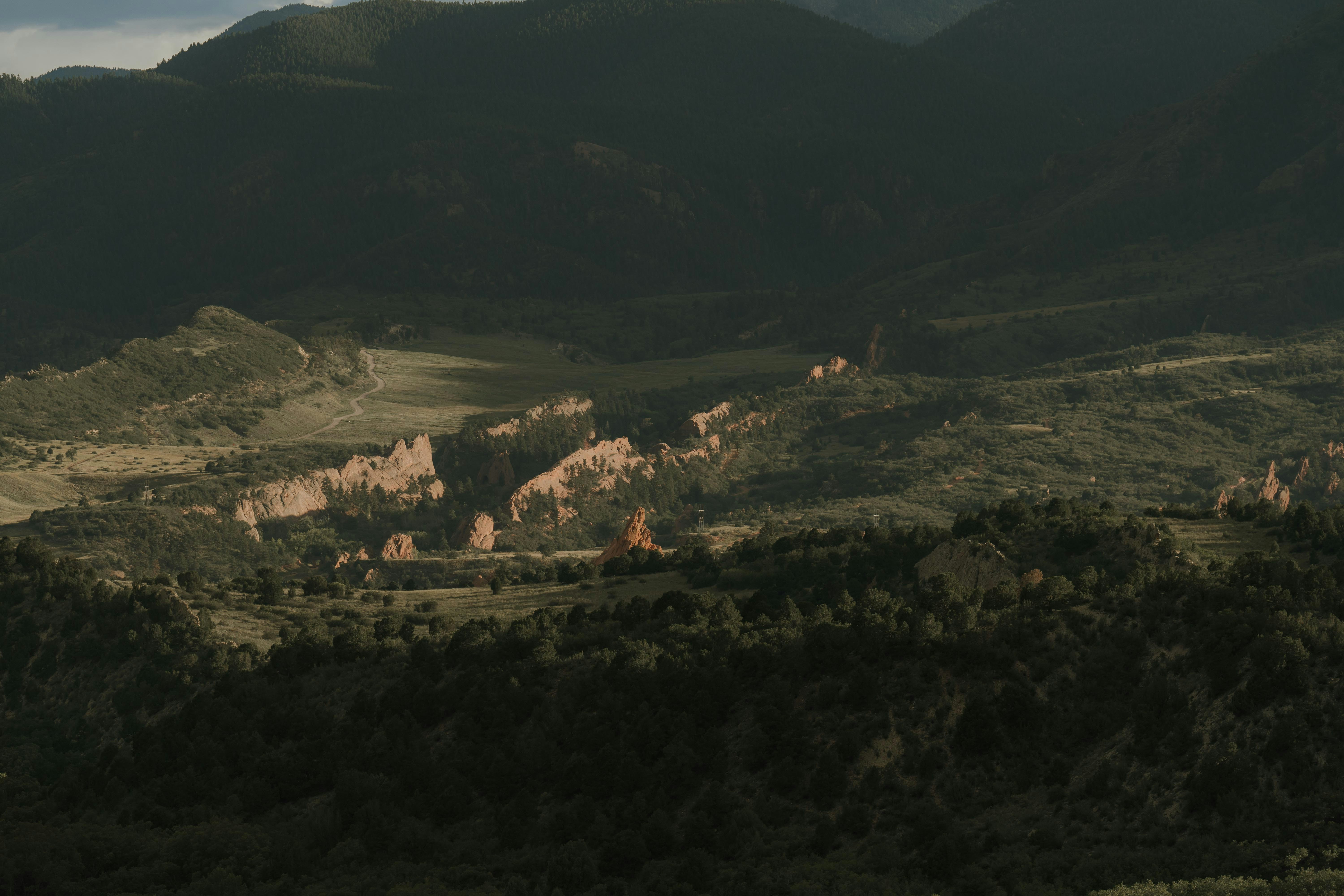a view of a valley with mountains in the background
