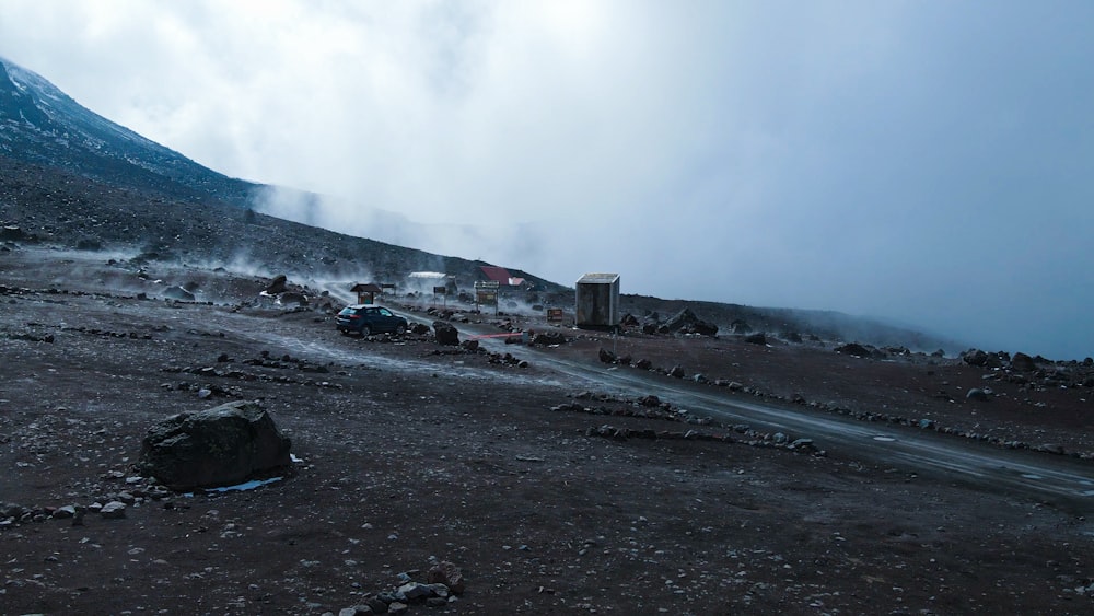 a dirt field with a mountain in the background