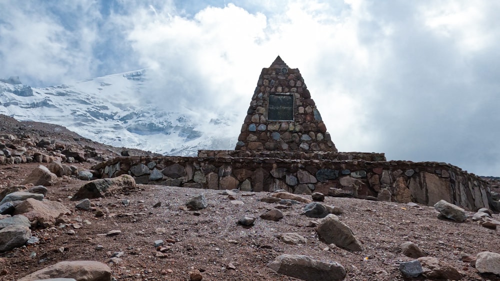 a stone structure with a window on top of a mountain