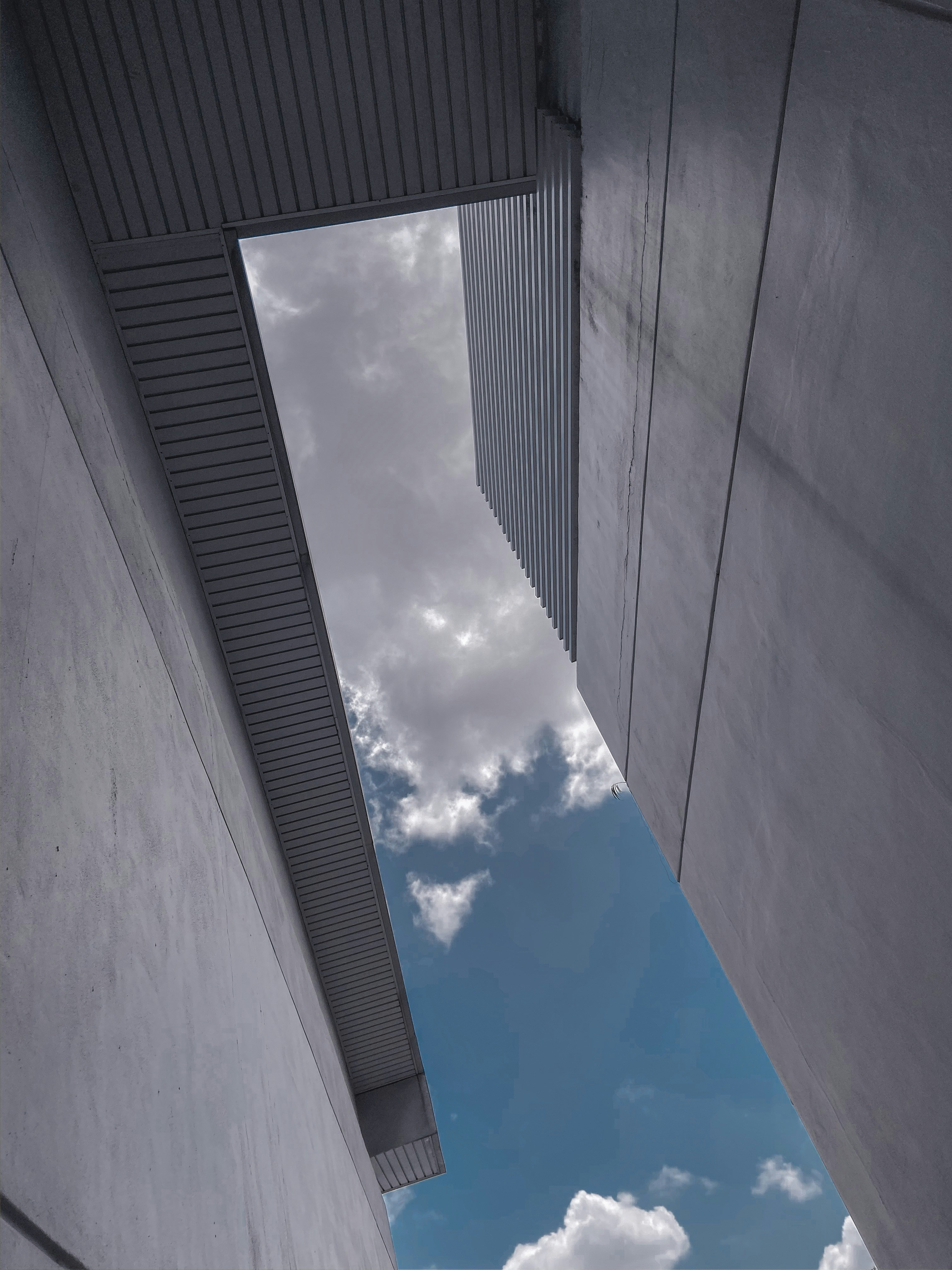looking up at the sky from between two buildings