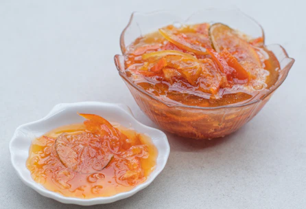 Close-up of traditional homemade goiabada and doce de leite in ceramic bowls.