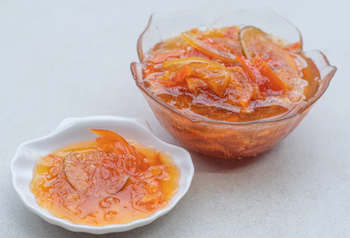Close-up of fresh, ripe fruits arranged in a colorful bowl ready for marmalade making