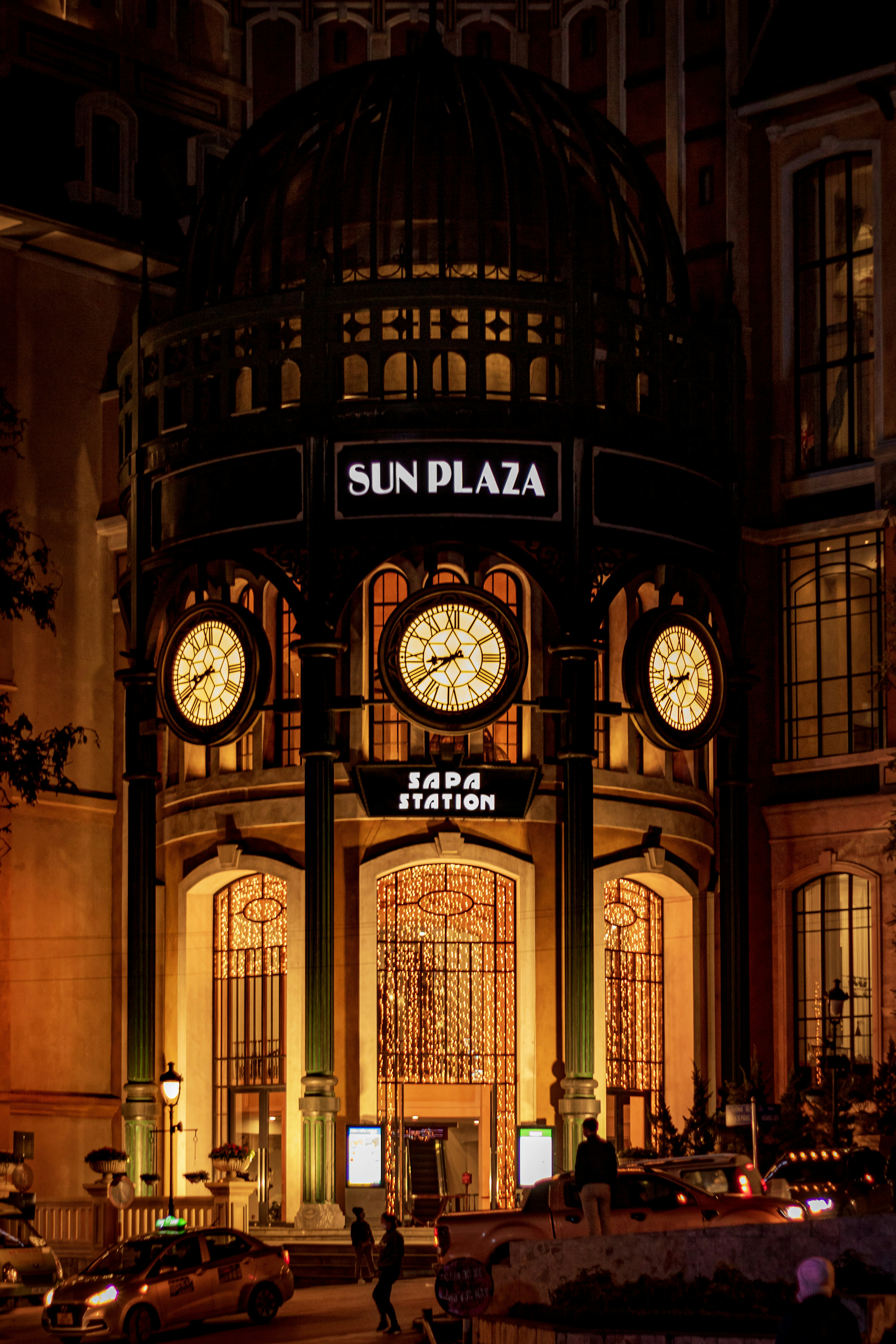 A large building with a lot of clocks on it photo – Free Night city ...