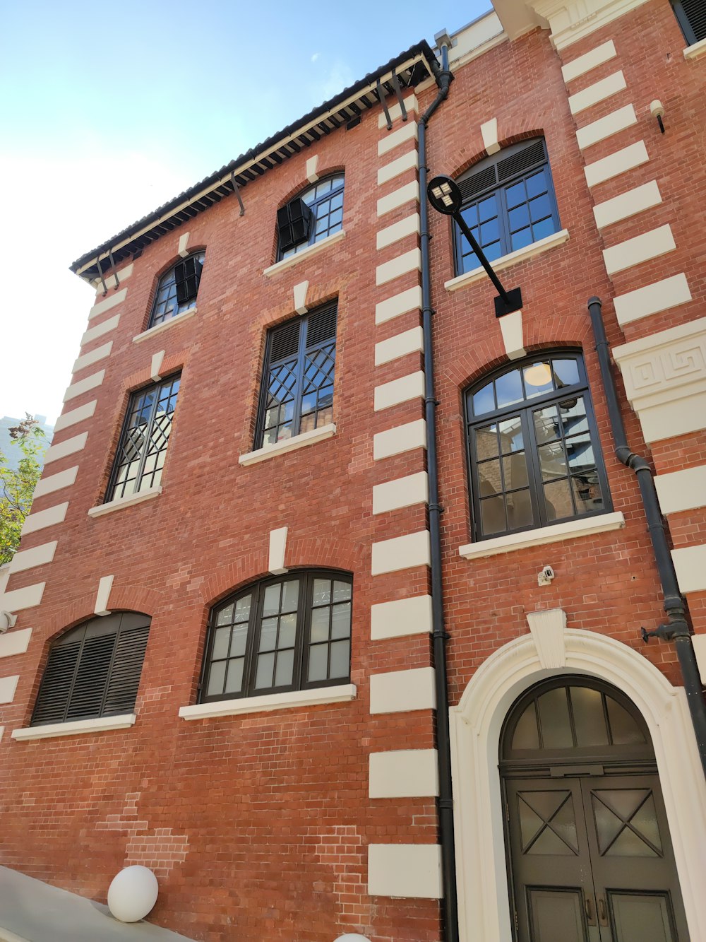 a tall brick building with a clock on the side of it