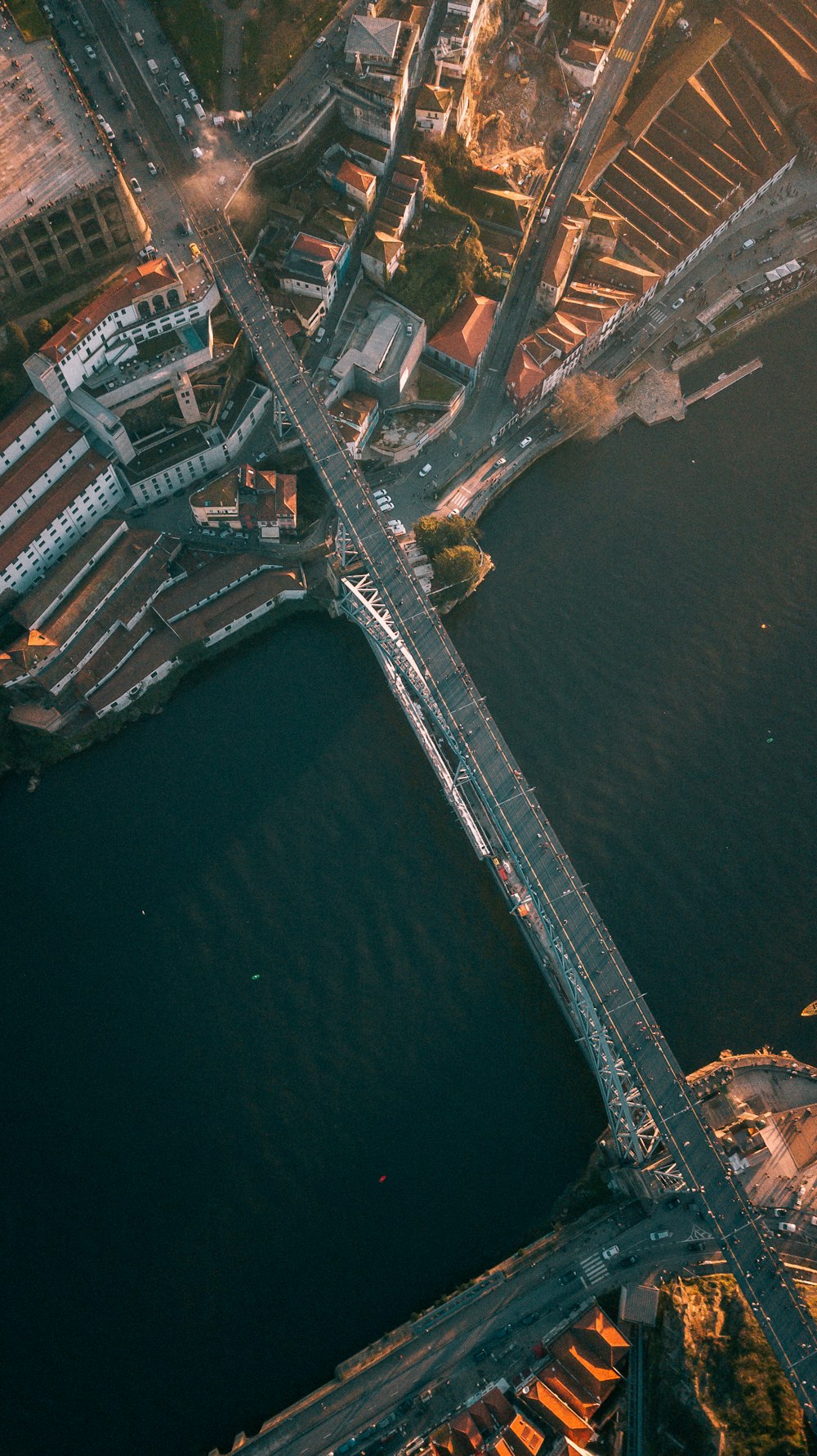 an aerial view of a bridge over a body of water