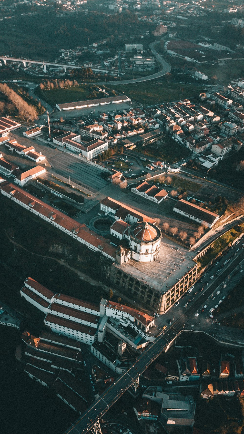 an aerial view of a city with a large building