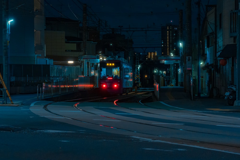 a train traveling down train tracks at night