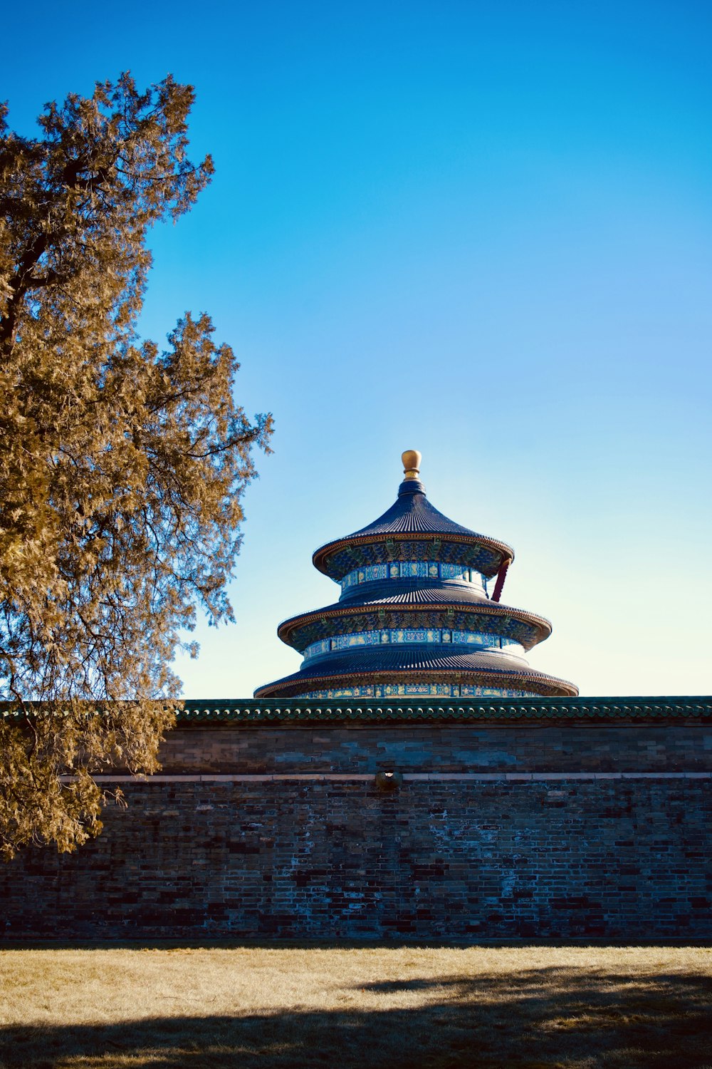 a tall building sitting on top of a brick wall