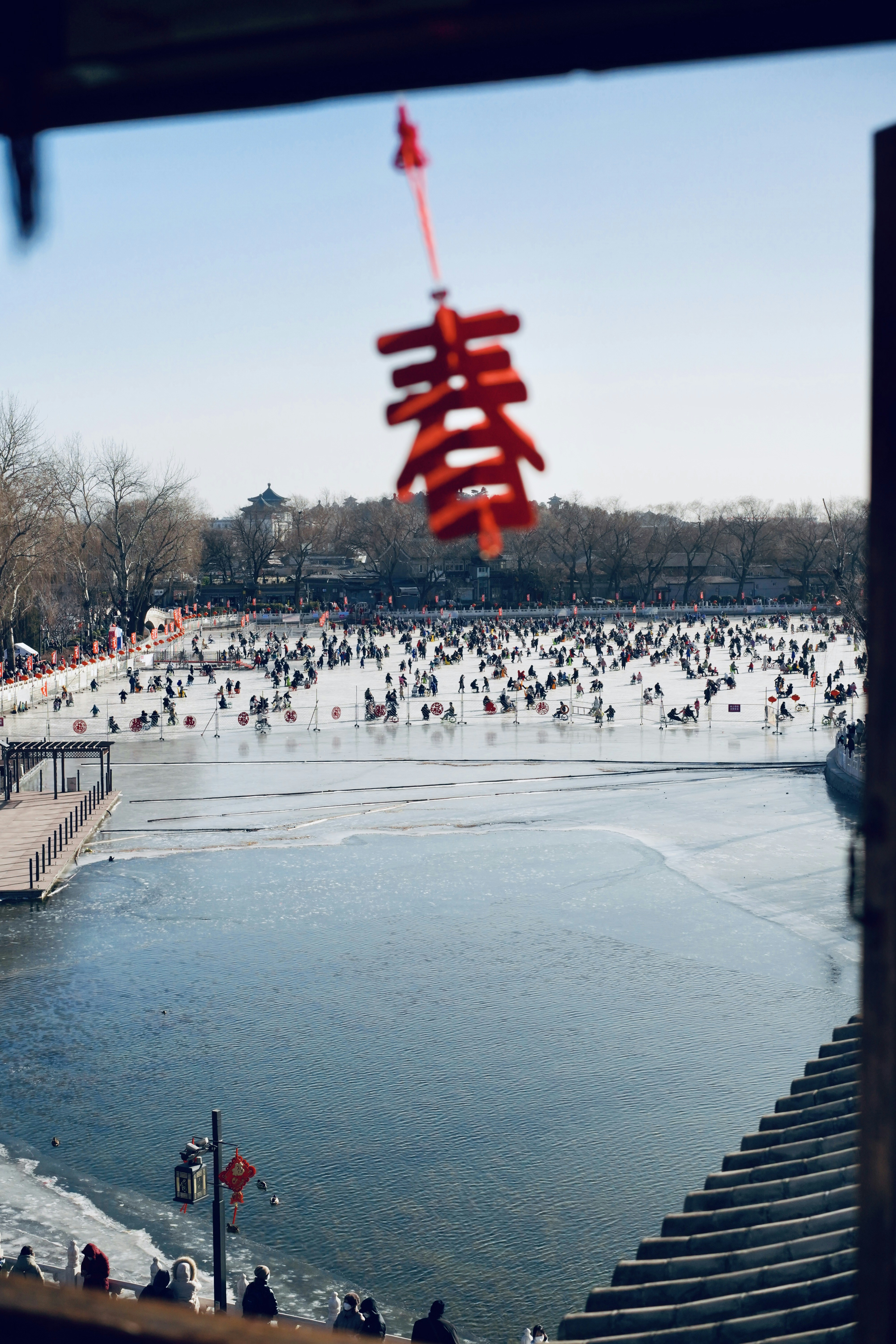 a group of people standing around a body of water