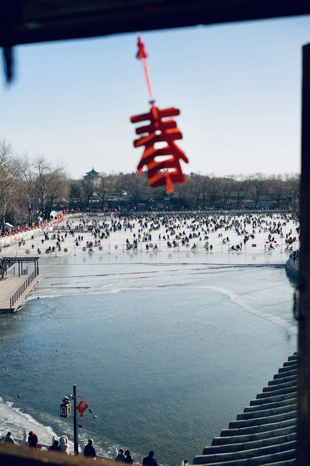 a group of people standing around a body of water