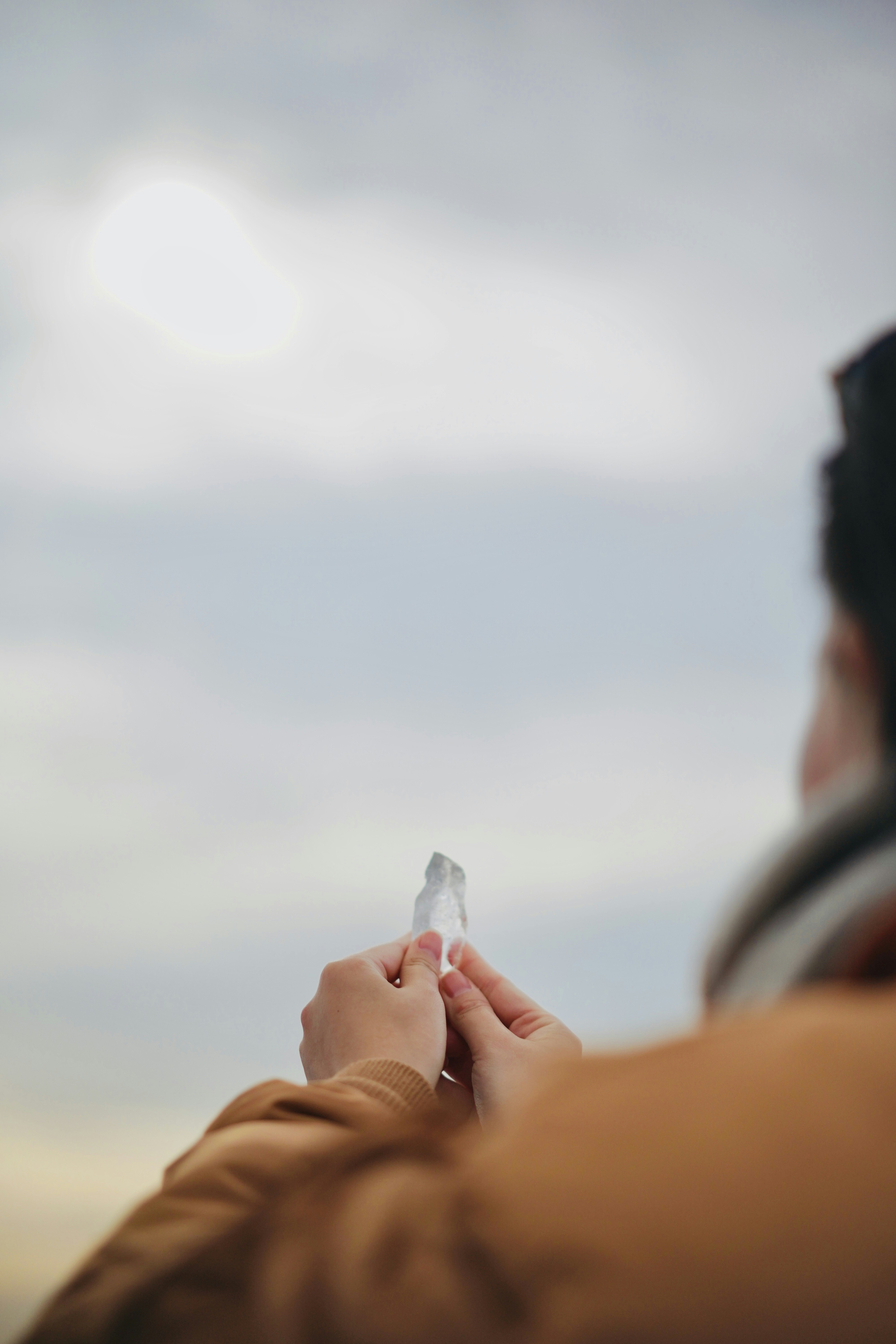 a person holding a small object in their hands