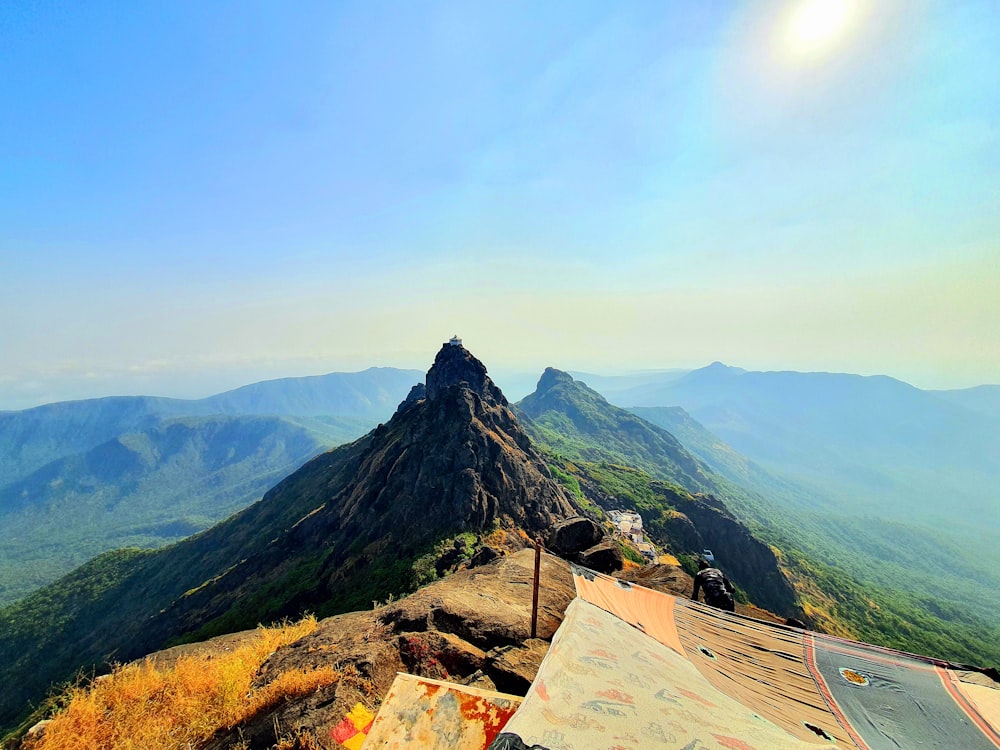 a view of a mountain range from the top of a hill