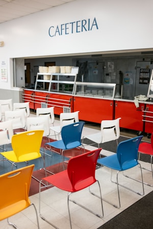 A school cafeteria lined with colorful chairs and tables, the setting for the free breakfast and lunch service CCSD is running districtwide in 2026-27