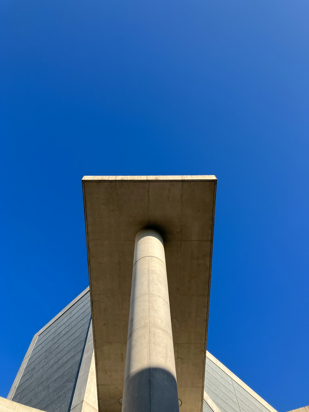 the top of a tall building with a blue sky in the background