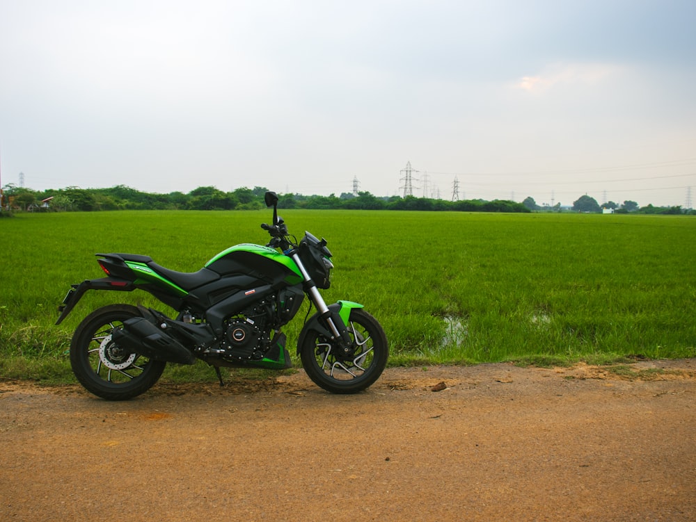 a motorcycle parked on the side of a dirt road