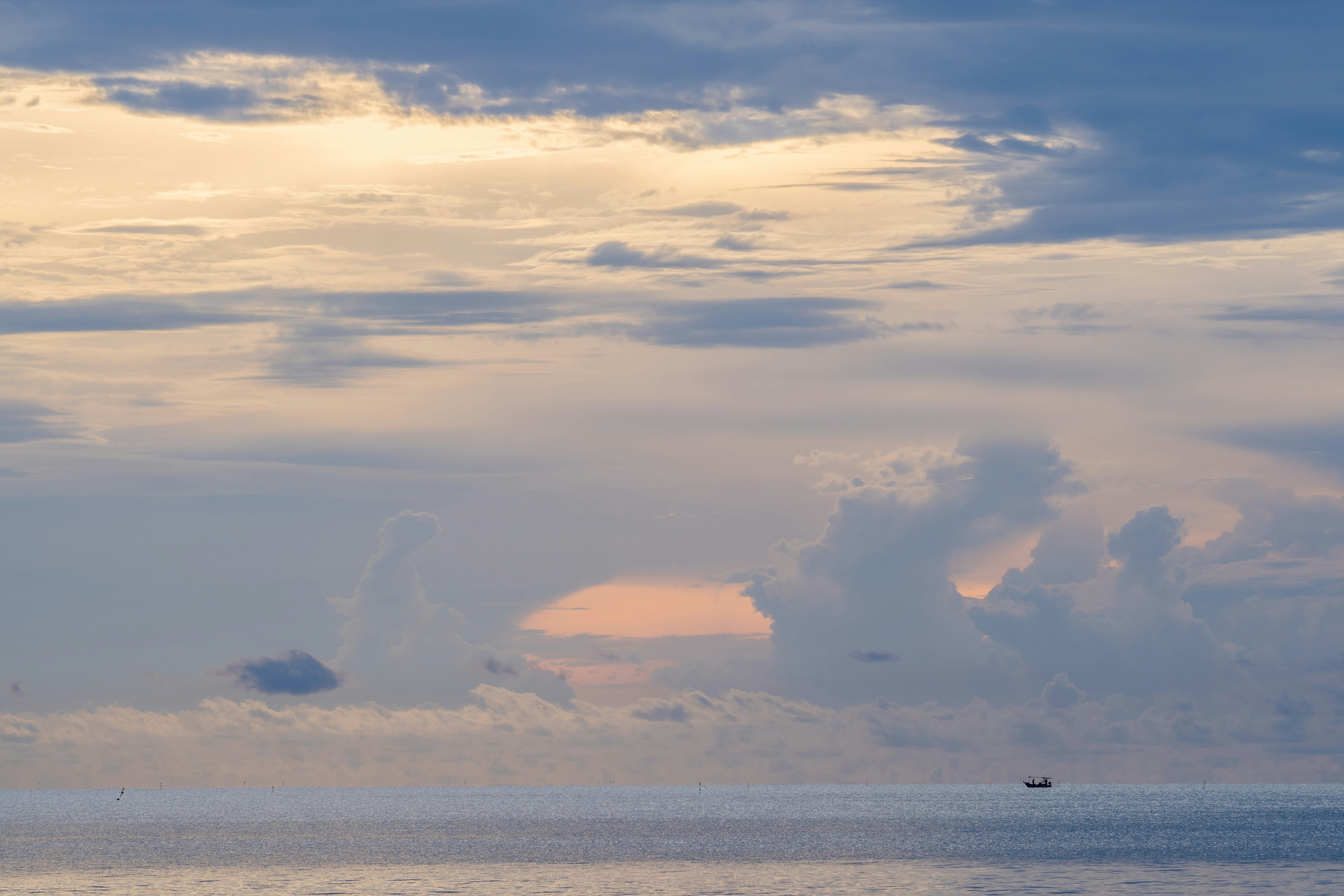 a large body of water under a cloudy sky