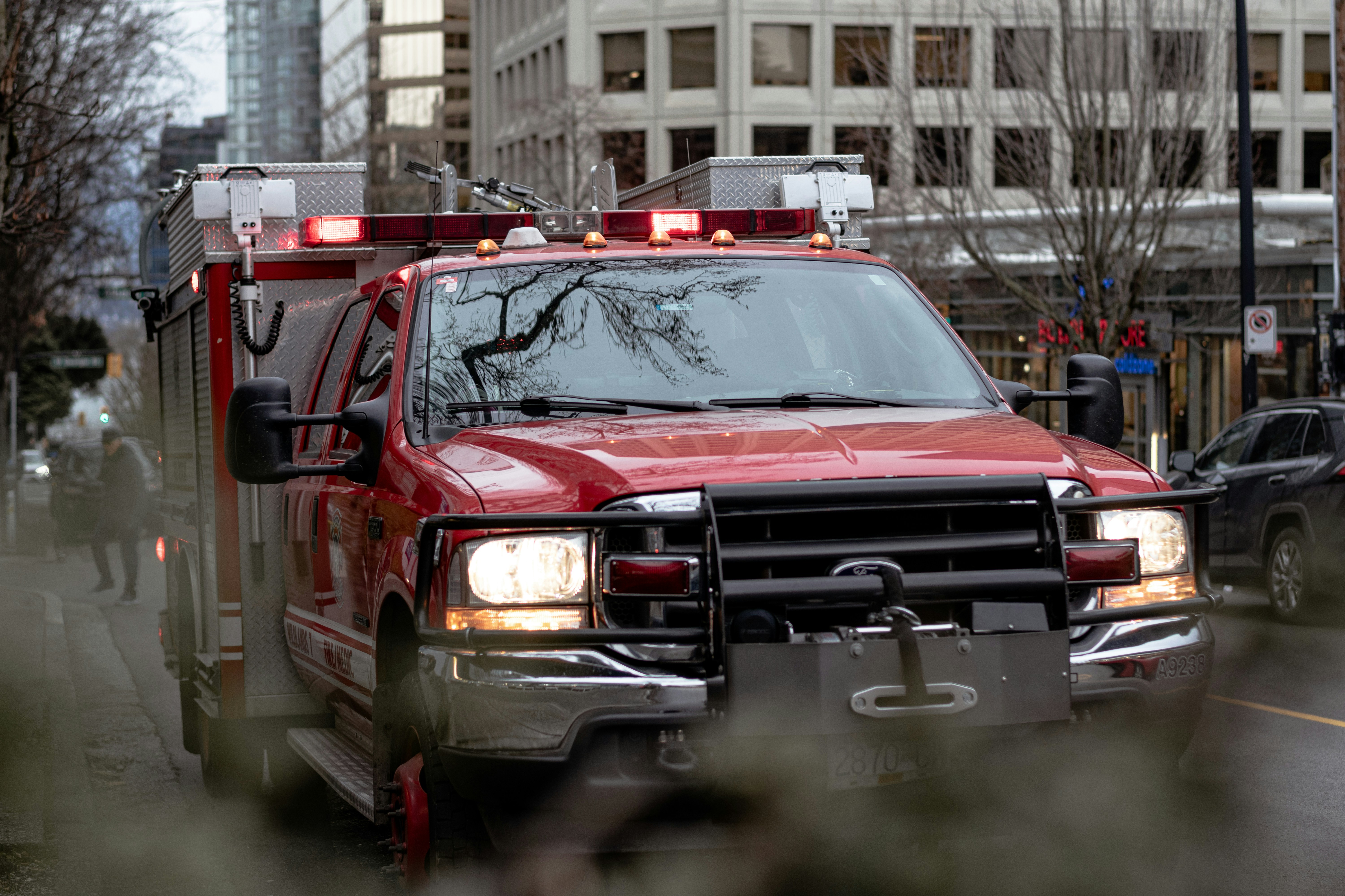 A Fire Truck Parked on the side of a road with lights on