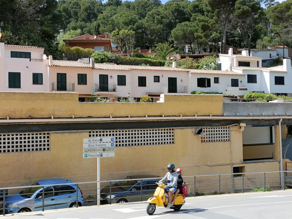 a person riding a scooter on a city street