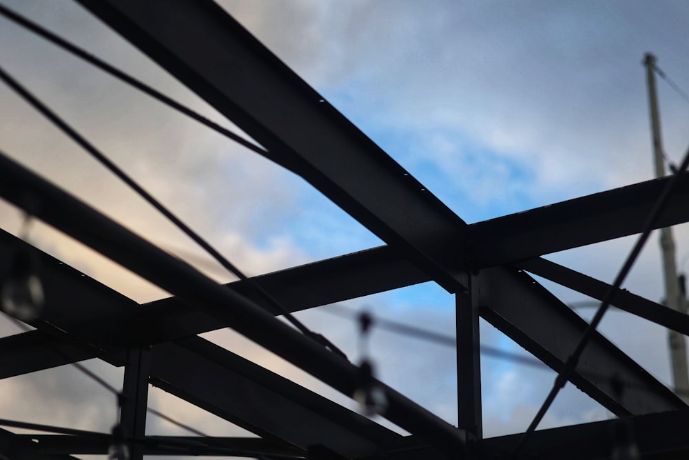 a close up of a metal structure under a cloudy sky