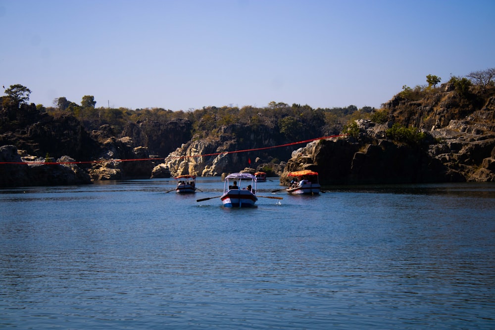 a group of boats floating on top of a lake