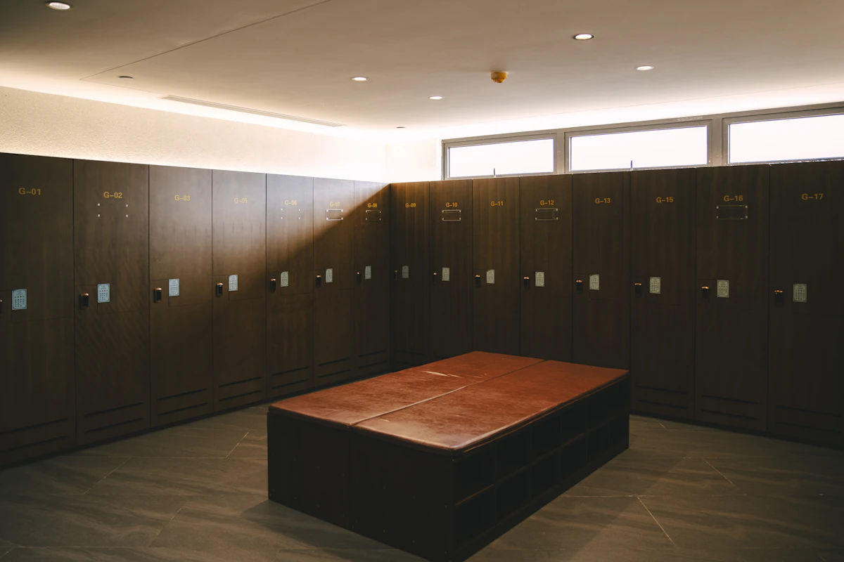Wood-paneled locker room with a central bench