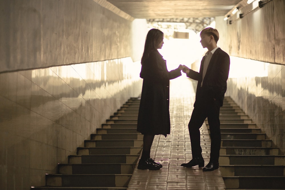 a man and a woman standing in a tunnel
